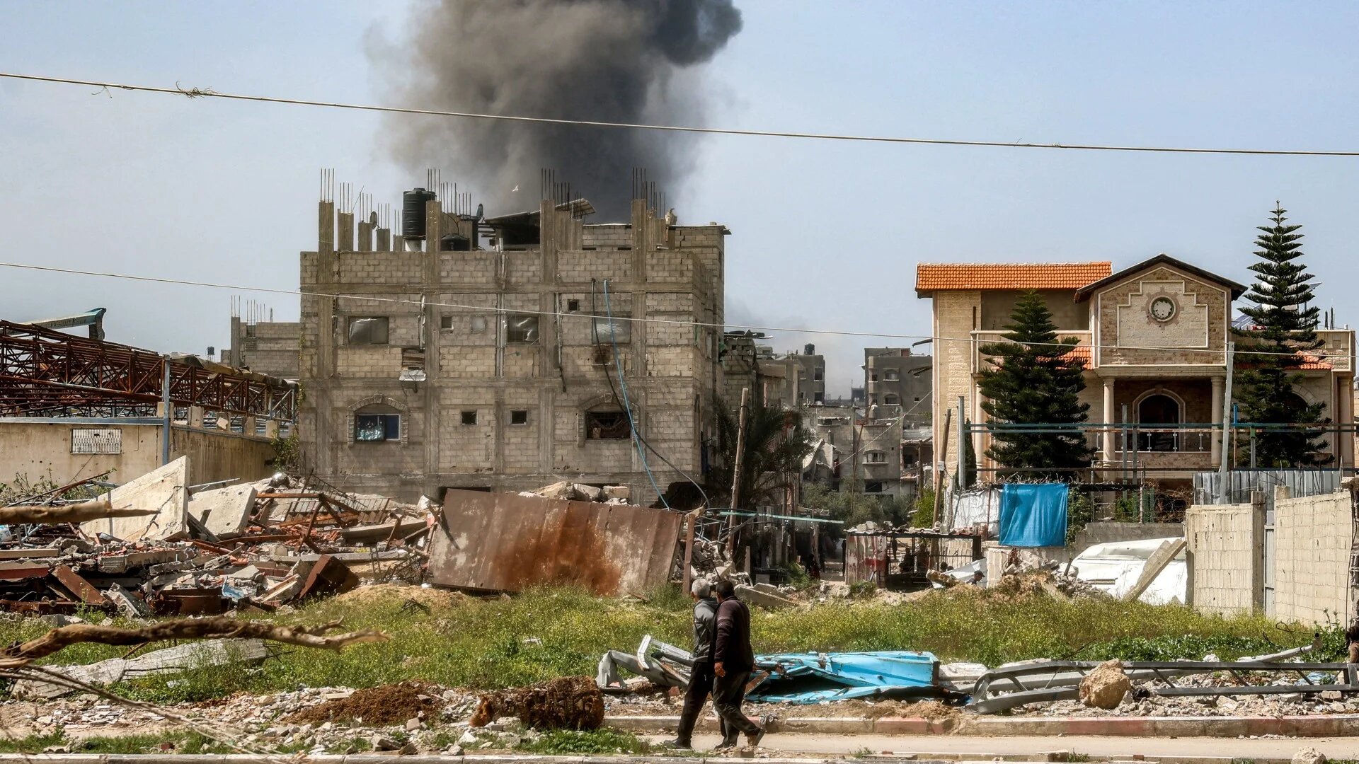 Smoke rises from a building that was hit by Israeli bombardment in the Nuseirat camp for Palestinian refugees in the central Gaza Strip on 25 March 2025 (AFP/Eyad Baba)