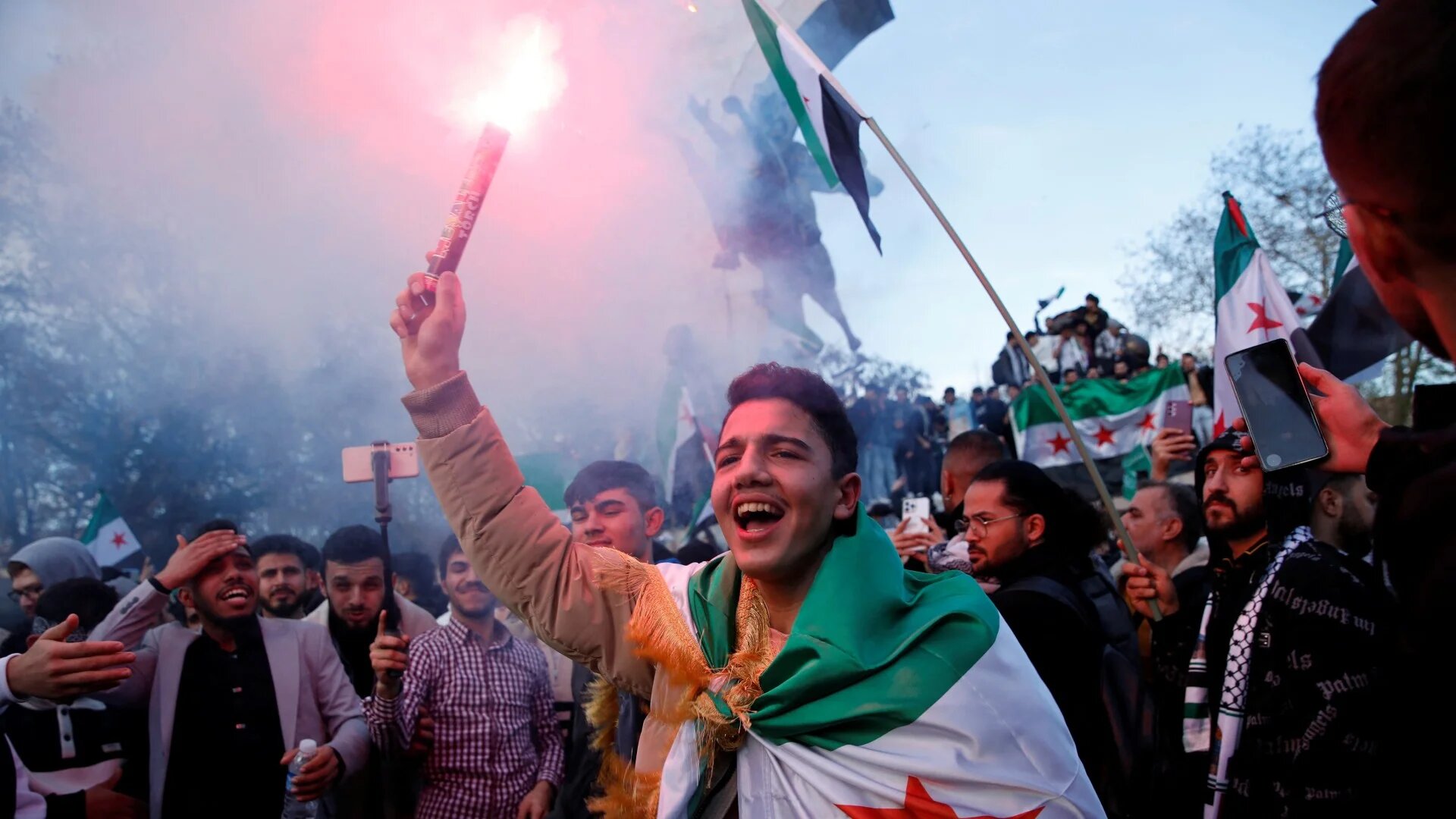 Syrians living in Turkey celebrate after rebels announced that they have ousted Bashar al-Assad in Syria, in Istanbul, 8 December (Reuters/Dilara Senkaya)