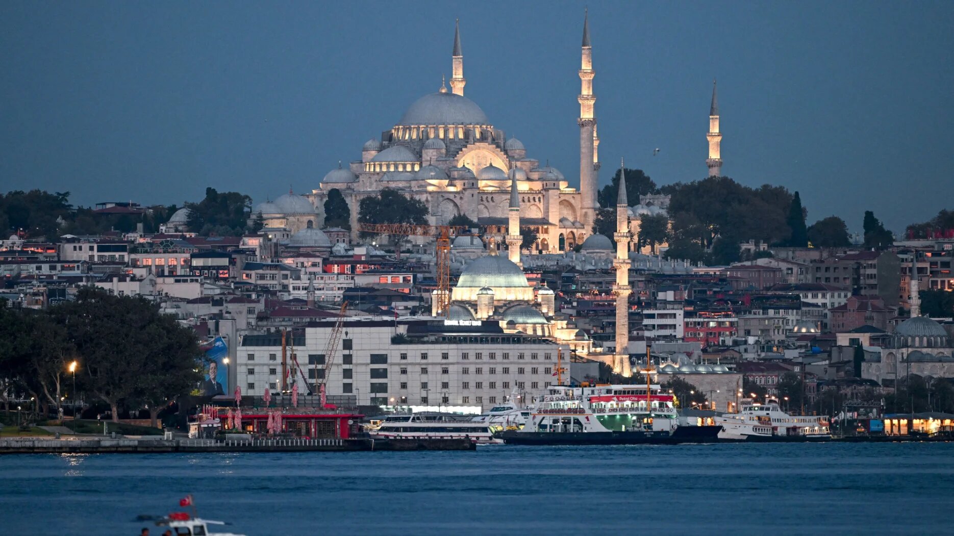 Fishermen fish on Bosphorus in Istanbul, on September 18, 2024 as Suleymaniye mosque is seen in the background (AFP)