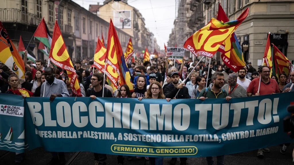 Pro-Palestinian protesters hold a banner reading “Let's Block Everything” during a union-organised nationwide strike in Turin, Italy, on 22 September 2025 (Marco Bertorello/AFP)