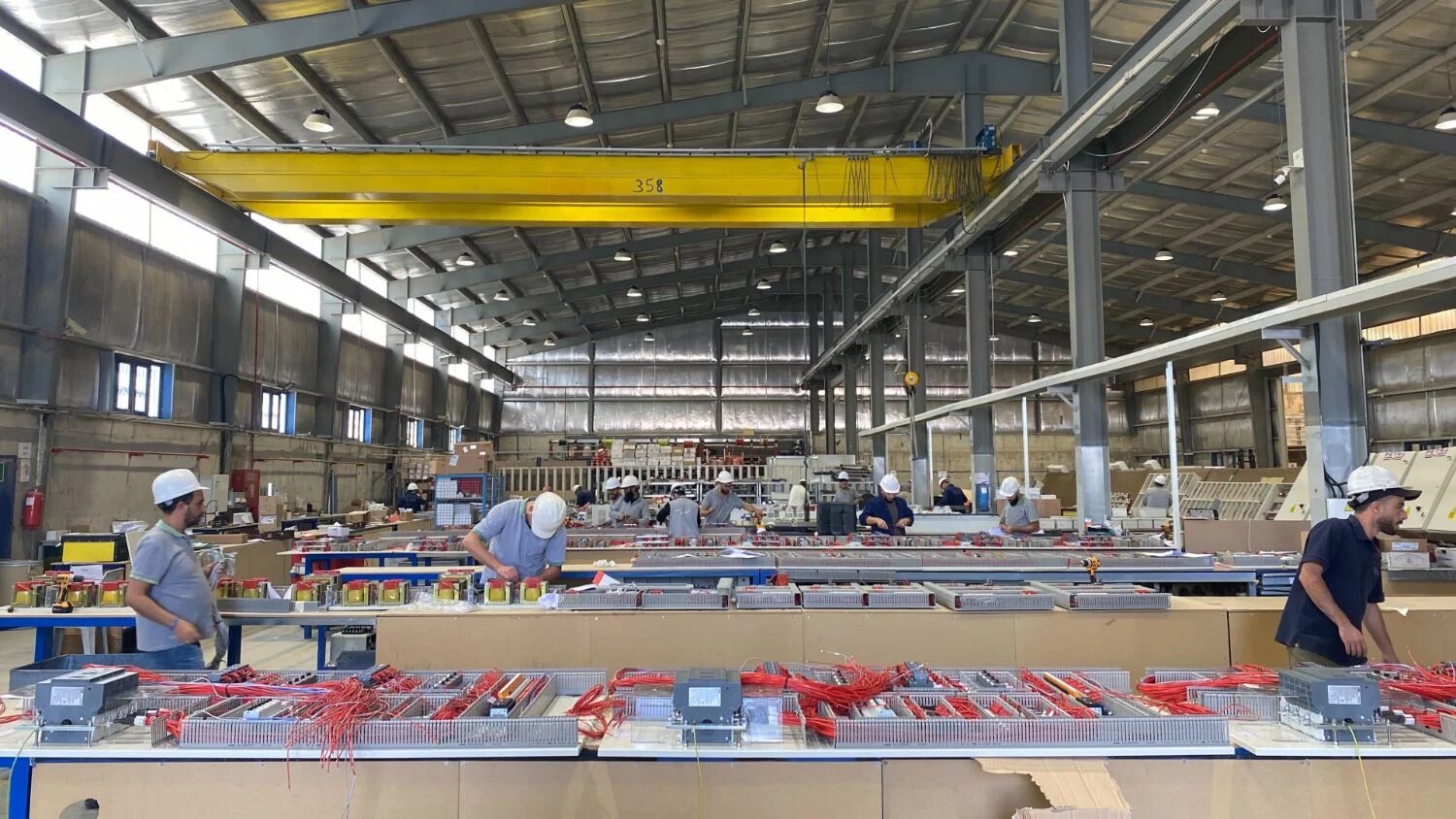 Workers at the electric panel assembly line of Petra Engineering Industries in al-Mwaqqar, Jordan, on 20 October 2022.