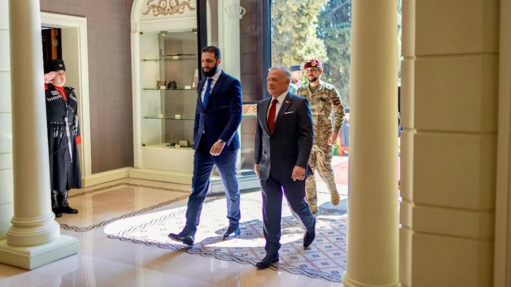 Syrian President Ahmed al-Sharaa walks alongside Jordan’s King Abdullah II in Amman on 26 February 2025 (Jordanian Royal Palace/AFP)