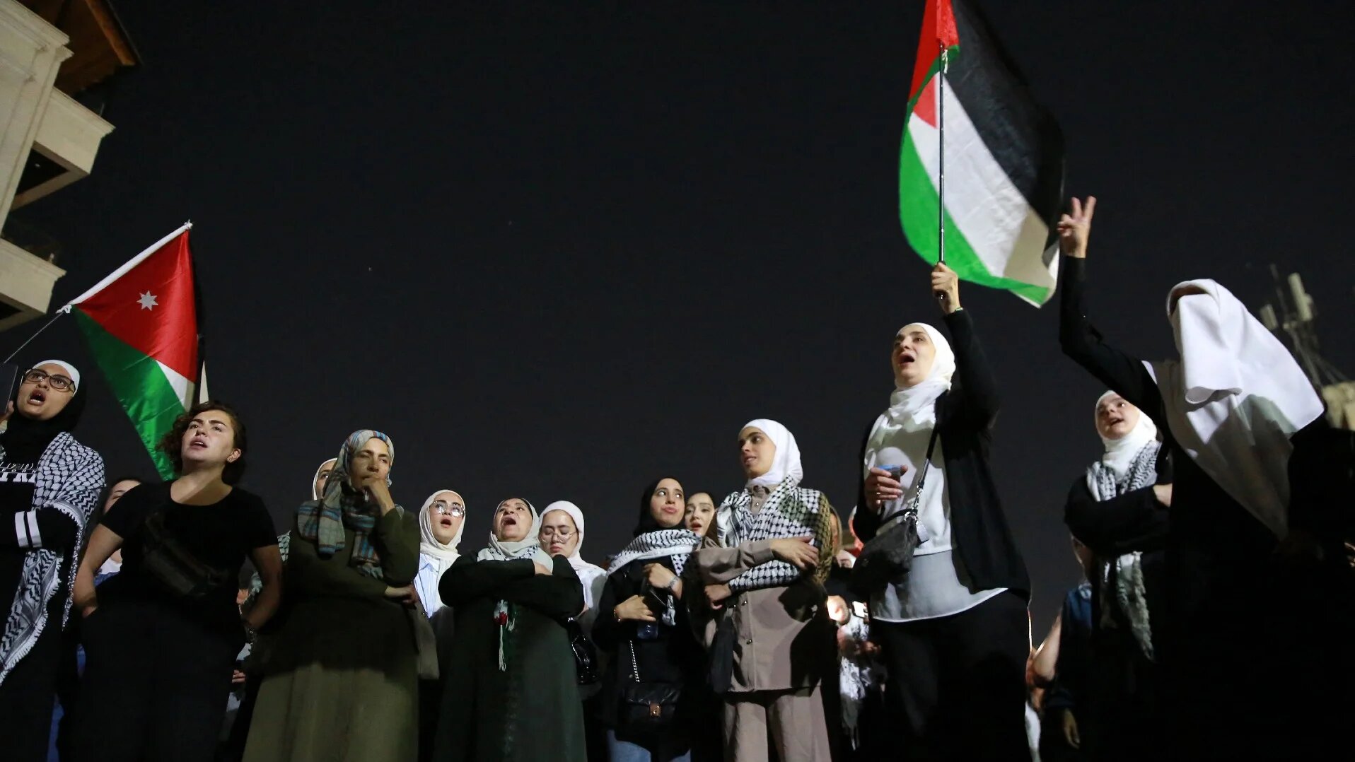 Jordanian women wave Palestinian flags as they protest near the Israeli embassy in Amman on 1 August 2024 (Stringer/AFP)
