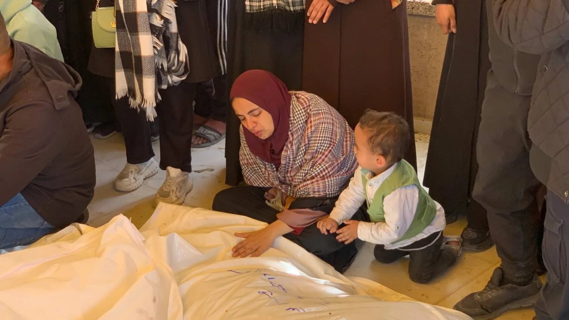 A woman mourns her relatives from the Qaoud family, killed by an Israeli air strike on 2 April 2025 (Ahmed Aziz/MEE)
