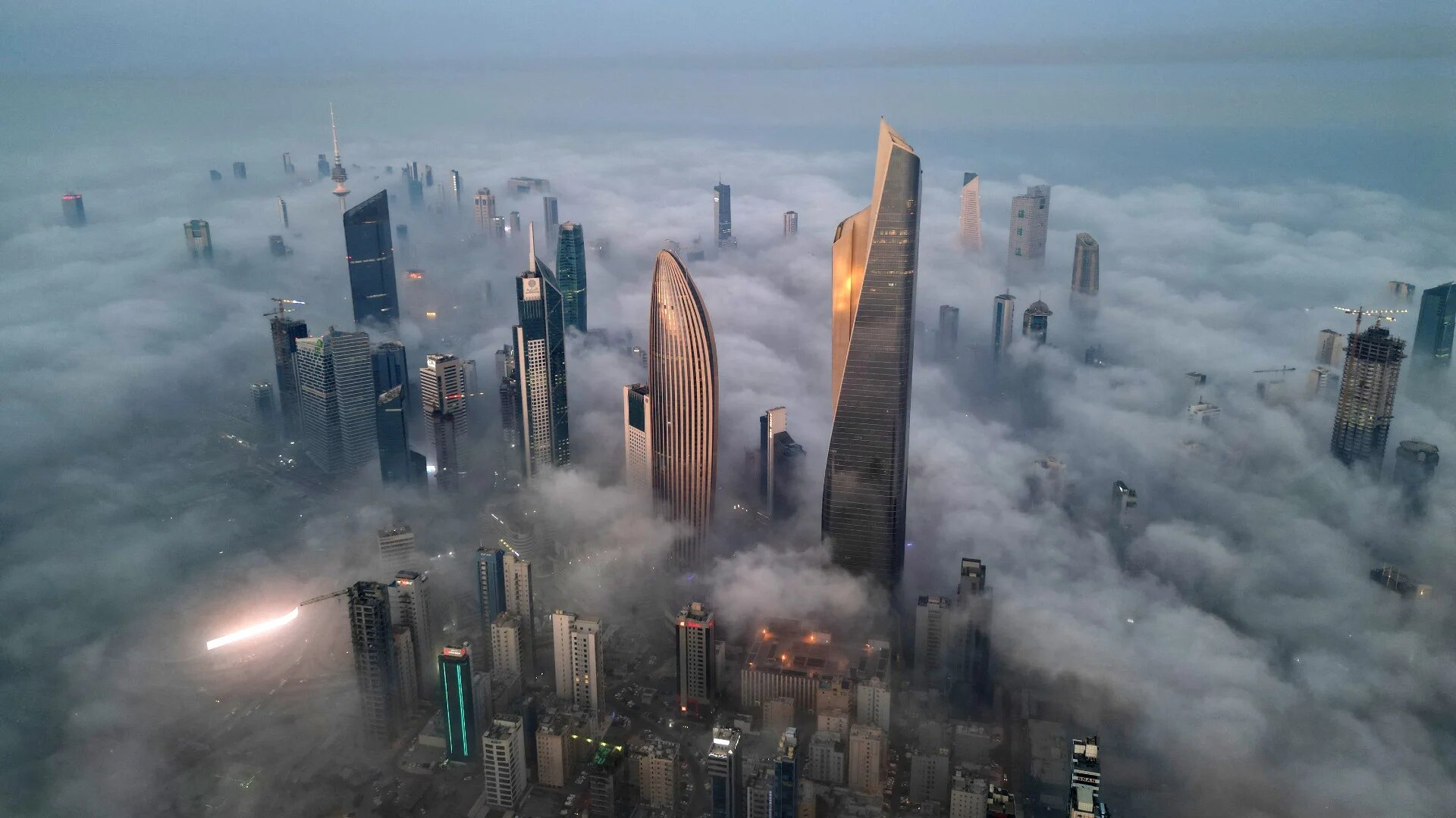 Skyscrapers enveloped in early morning foggy in Kuwait City on 9 November 2025 (Yasser al-Zayyat/AFP)