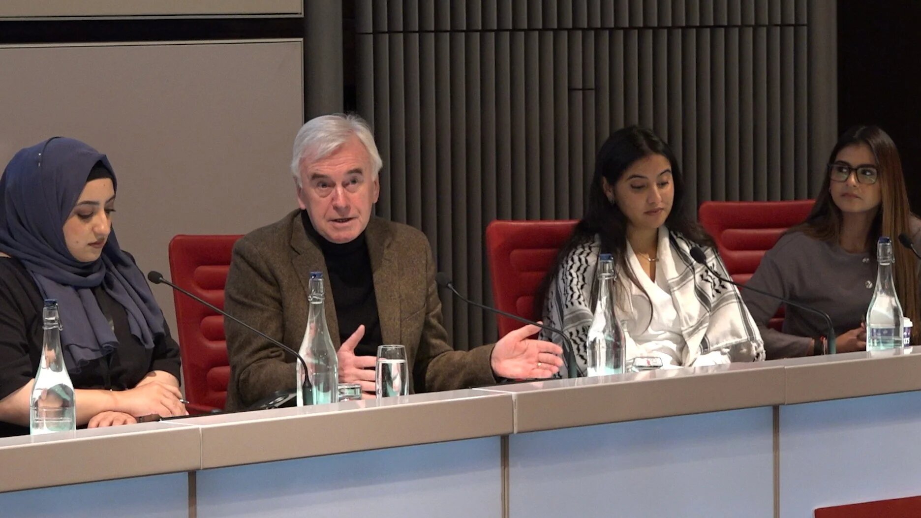 Labour MP John McDonnell (C) addresses attendees at the Labour Muslim Network conference in central London on 6 December 2025 (Emily Duchenne/MEE)
