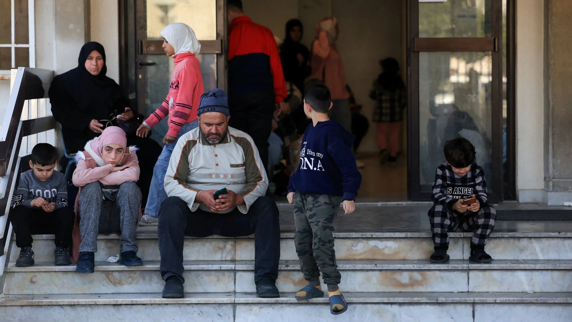 Displaced people gather at a school turned into a shelter following an escalation between Hezbollah and Israel, amid the US-Israeli conflict with Iran, in Beirut, 3 March 2026 (Reuters/Mohamed Azakir)
