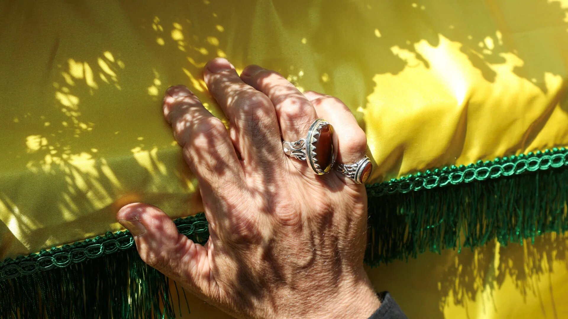 A mourner touches the coffin of Taleb Abdallah, a senior field commander of Hezbollah, during his funeral in Beirut 12 June (Reuters/Mohamed Azakir)