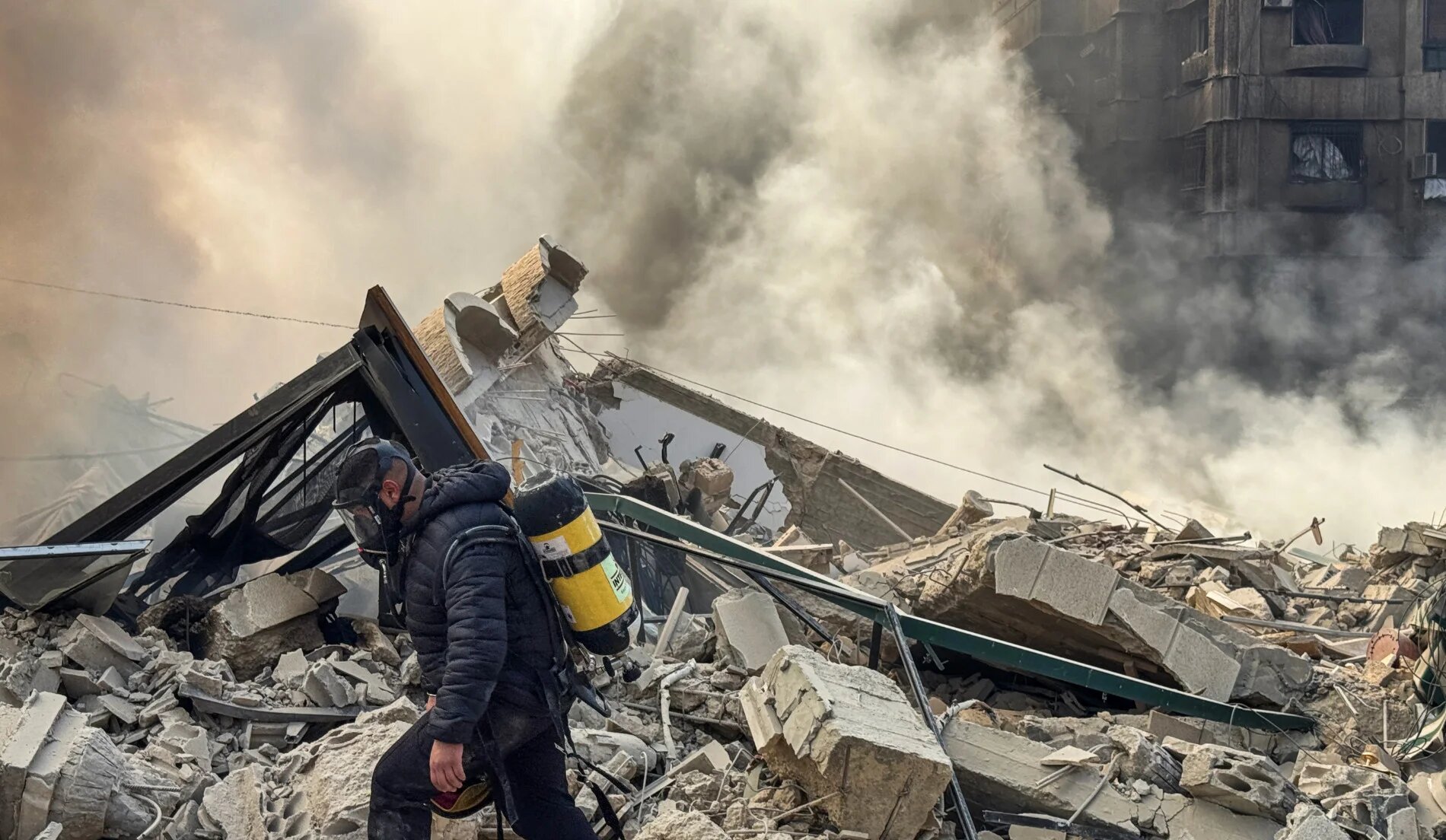 A firefighter inspects destruction at a site of an Israeli air strike in the southern suburbs of Beirut on 3 March 2026 (AFP)