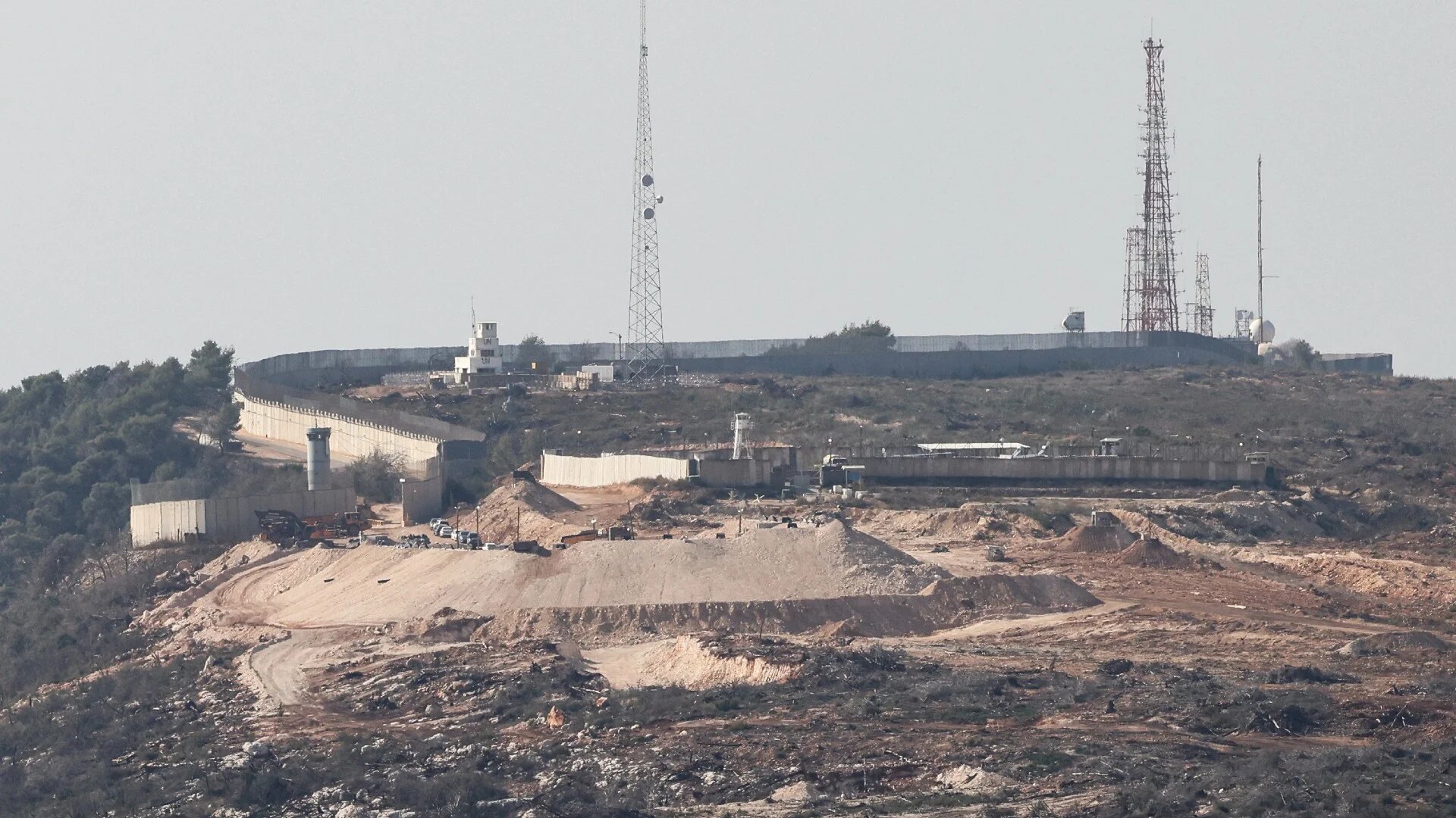 This photograph shows an Israeli position (front) next to a United Nations Interim Force in Lebanon (UNIFIL) base (background) near the village of Labbouneh, as seen from Alma Al-Shaab on 28 November 2025 (Anwar Amro/AFP)