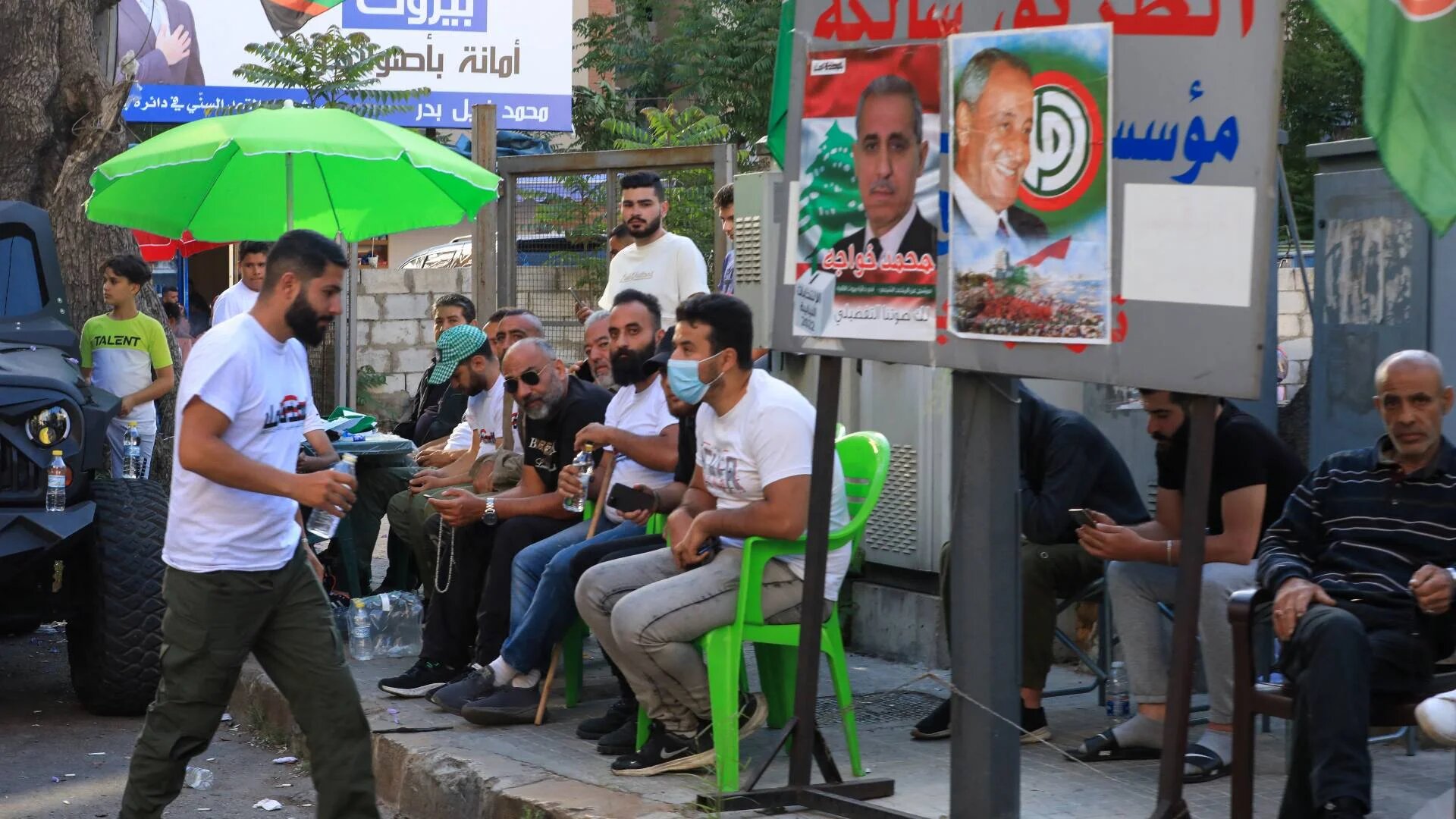 Supporters of Lebanon's Shiite Amal movement sit at the party's delegates point outside a polling station during Lebanon's parliamentary elections in the capital Beirut on 15 May 2022.