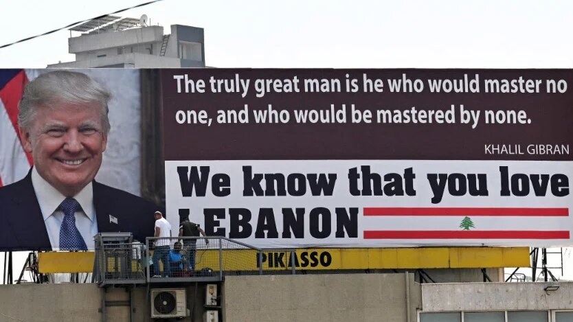 Workers install a billboard praising US President Donald Trump in the Lebanese capital, Beirut, on 24 July 2025 (Joseph Eid/AFP)