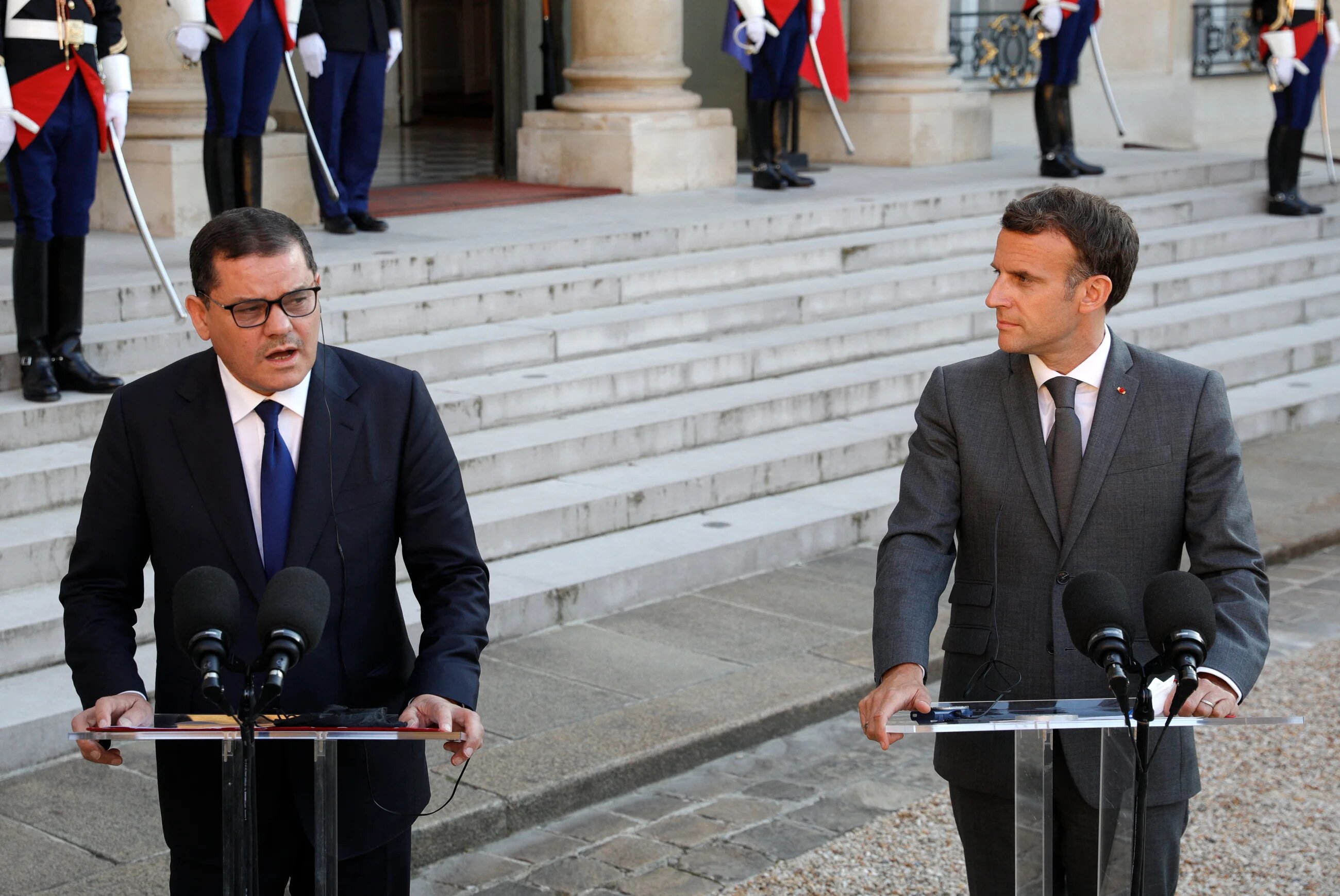Libya's Interim Prime Minister Abdul Hamid Dbeibah (L) and French President Emmanuel Macron 
