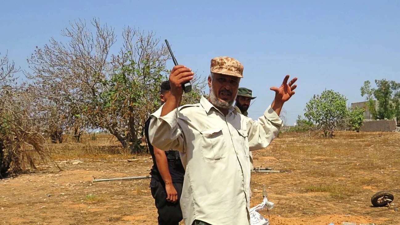Having packed sandbags over a grenade, Colonel Naji al-Garabli describes the upcoming blast (MEE/Daniel Hilton)