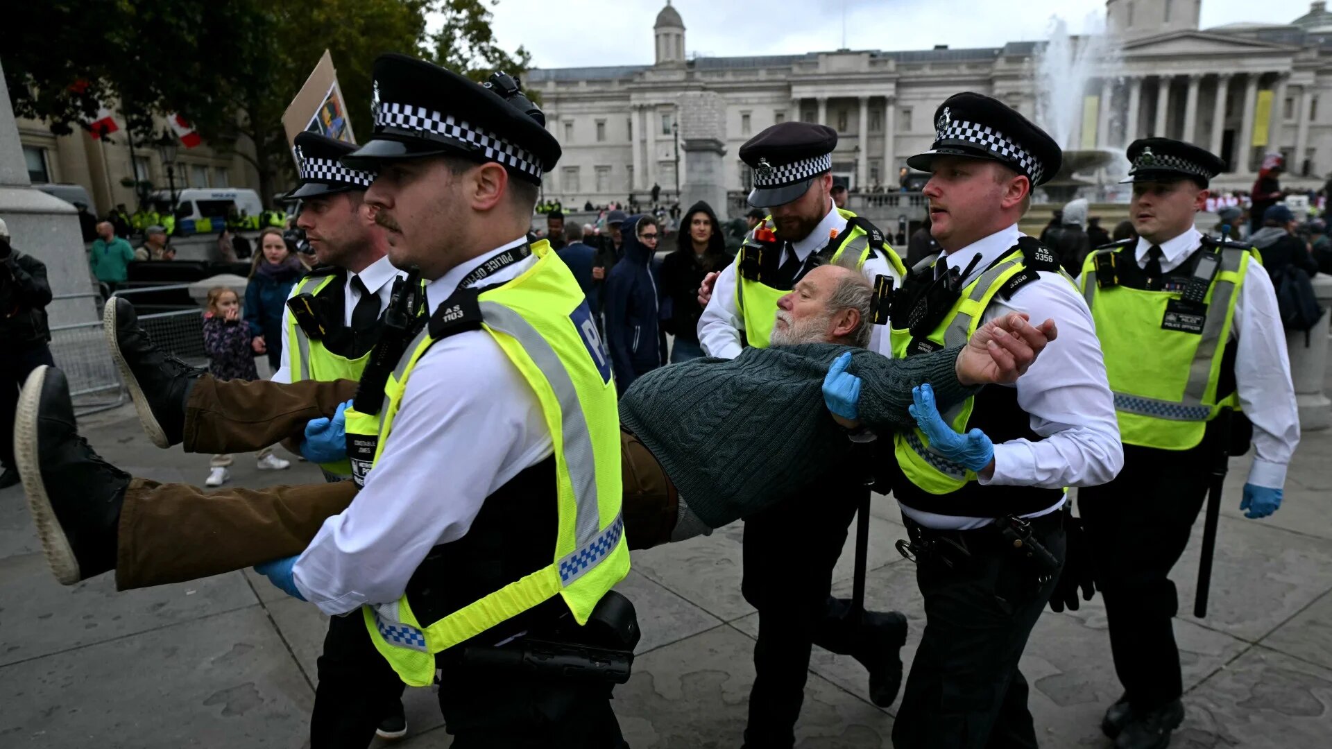 A protester is taken away by police officers at a "Lift The Ban" demonstration in support of the proscribed group Palestine Action, calling for the recently imposed ban to be lifted, in central London, on 4 October 2025 (AFP/Justin Tallis)