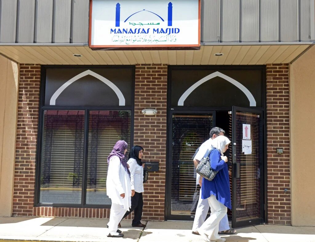 People pass one of the entrances of the Manassas Mosque in Manassas, Virginia.