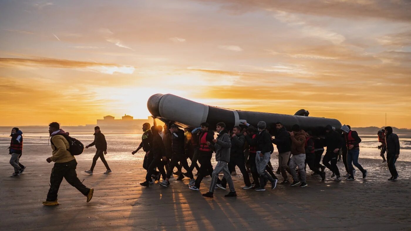 Refugees preparing a boat for the voyage from France to England, October 2022 (AFP)