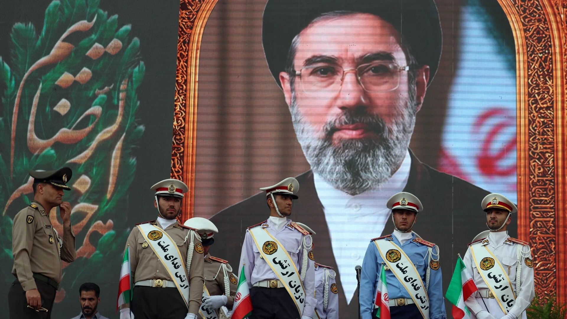 Iranian army soldiers stand in front of a picture of Iran's supreme leader Ayatollah Mojataba Khamenei in Tehran on 29 April 2026 (AFP)