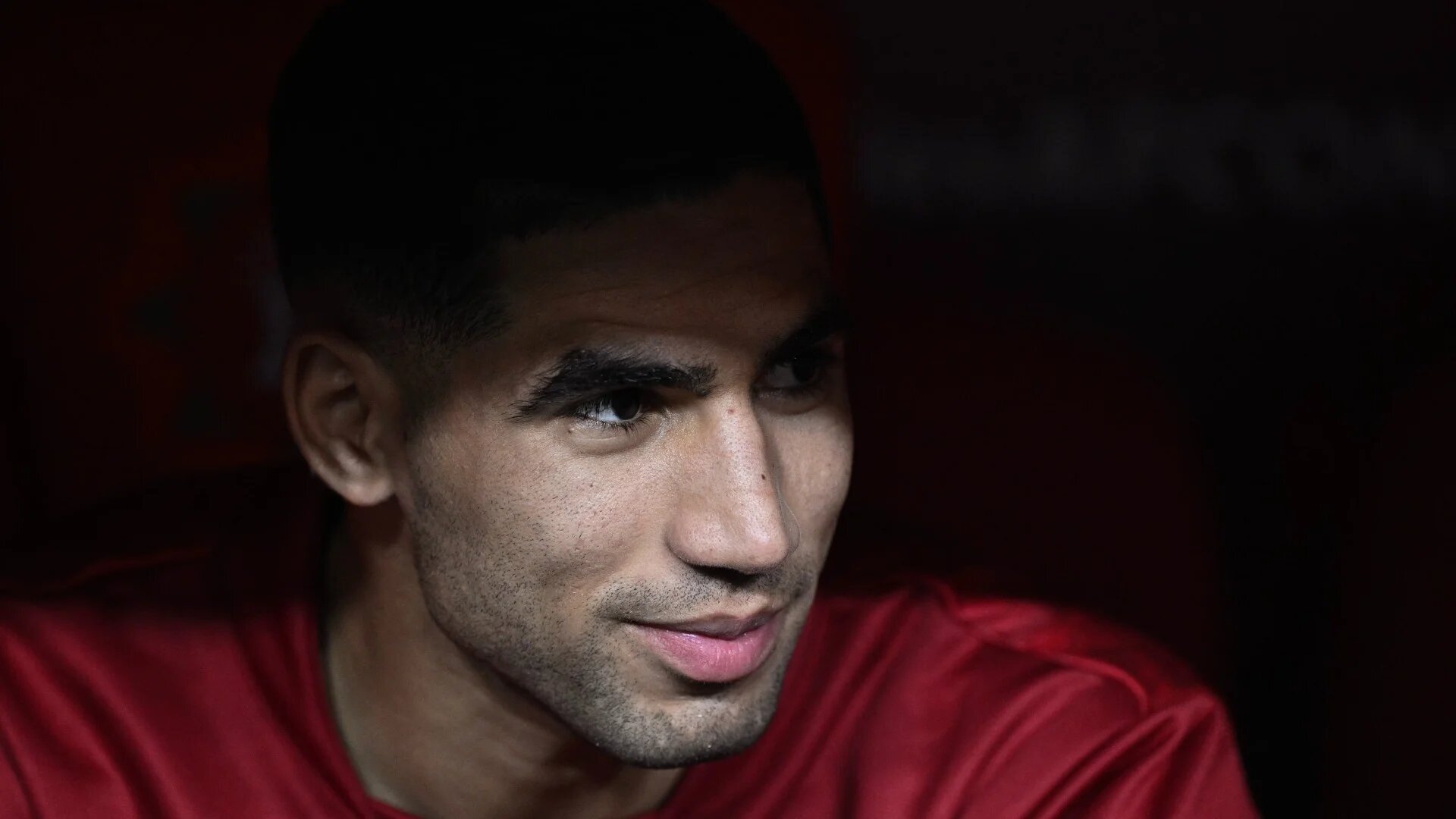 Morocco's Achraf Hakimi looks on from the substitutes bench at the Prince Moulay Abdellah Stadium in Rabat on 29 December 2025 (AFP/Gabriel Bouys)