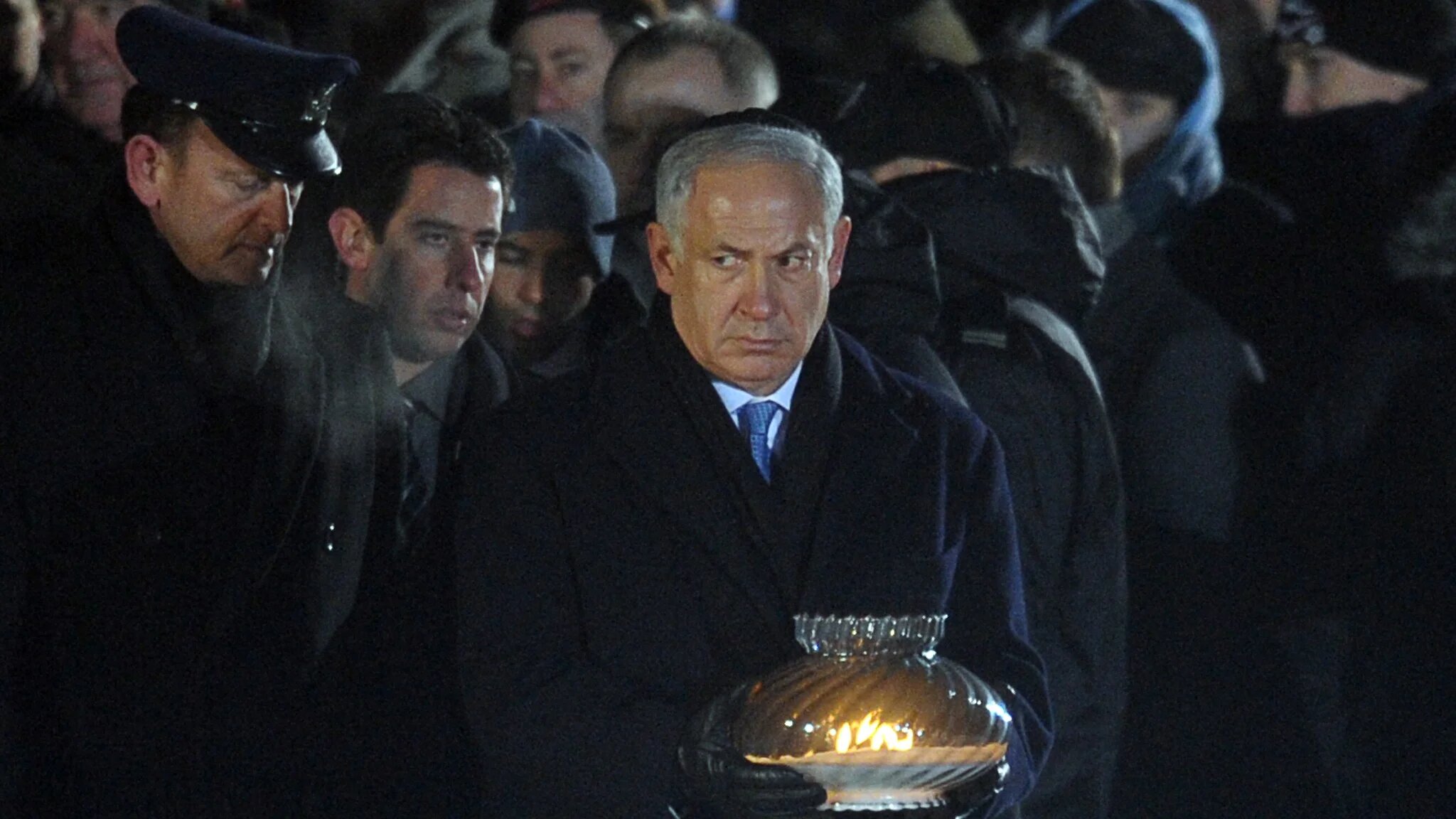 Israeli Prime Minister Benjamin Netanyahu carries a candle at the foot of a monument to the camp's victims in the former Nazi death camp of Auschwitz-Birkenau on 27 January 2010 (AFP/Janek Skarzynski)