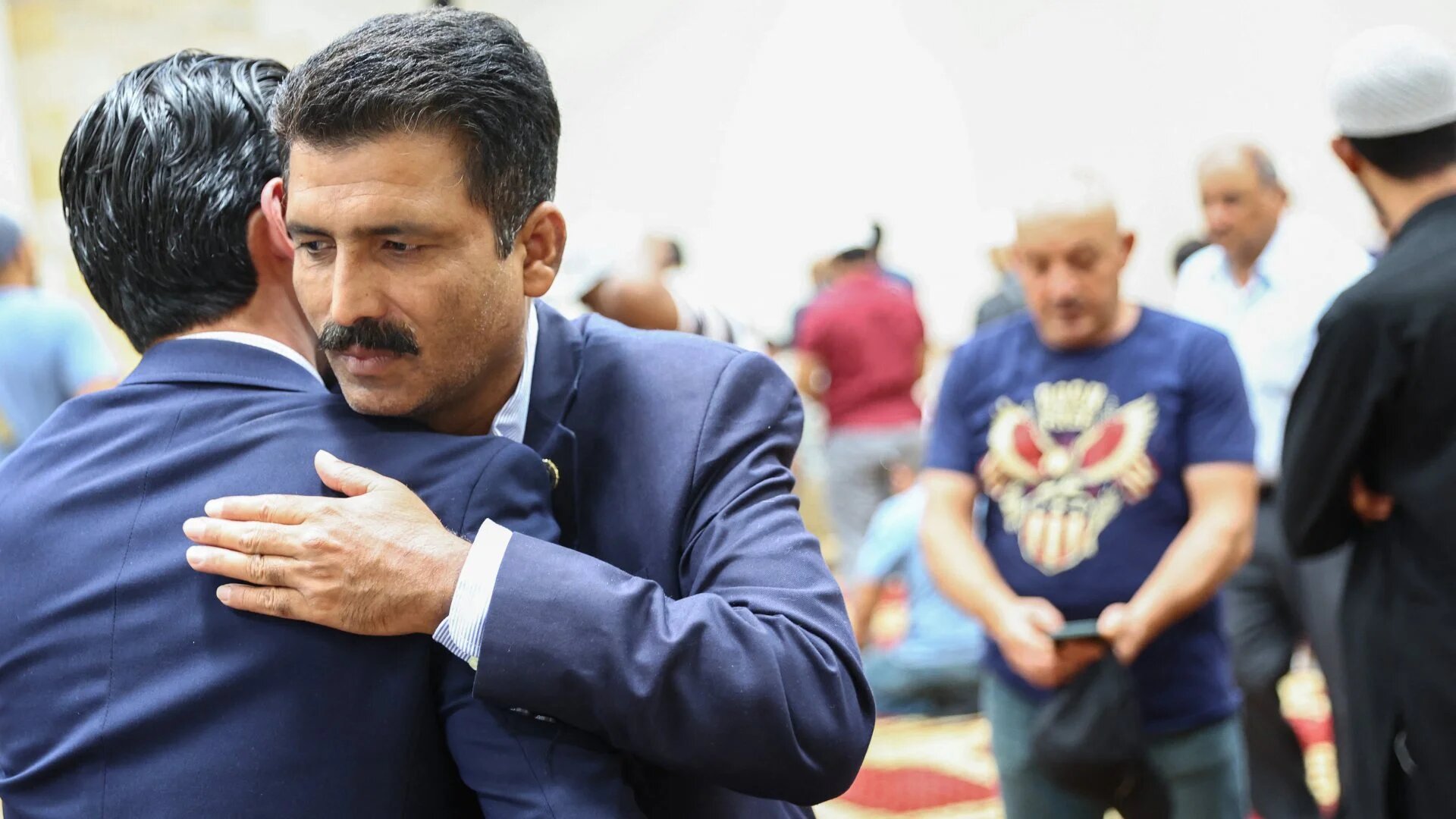 Muhammad Imtiaz Hussain, brother of victim Muhammad Afzaal Hussain, is embraced following Friday prayers at the Islamic Center of New Mexico on 12 August 2022 in Albuquerque, New Mexico.
