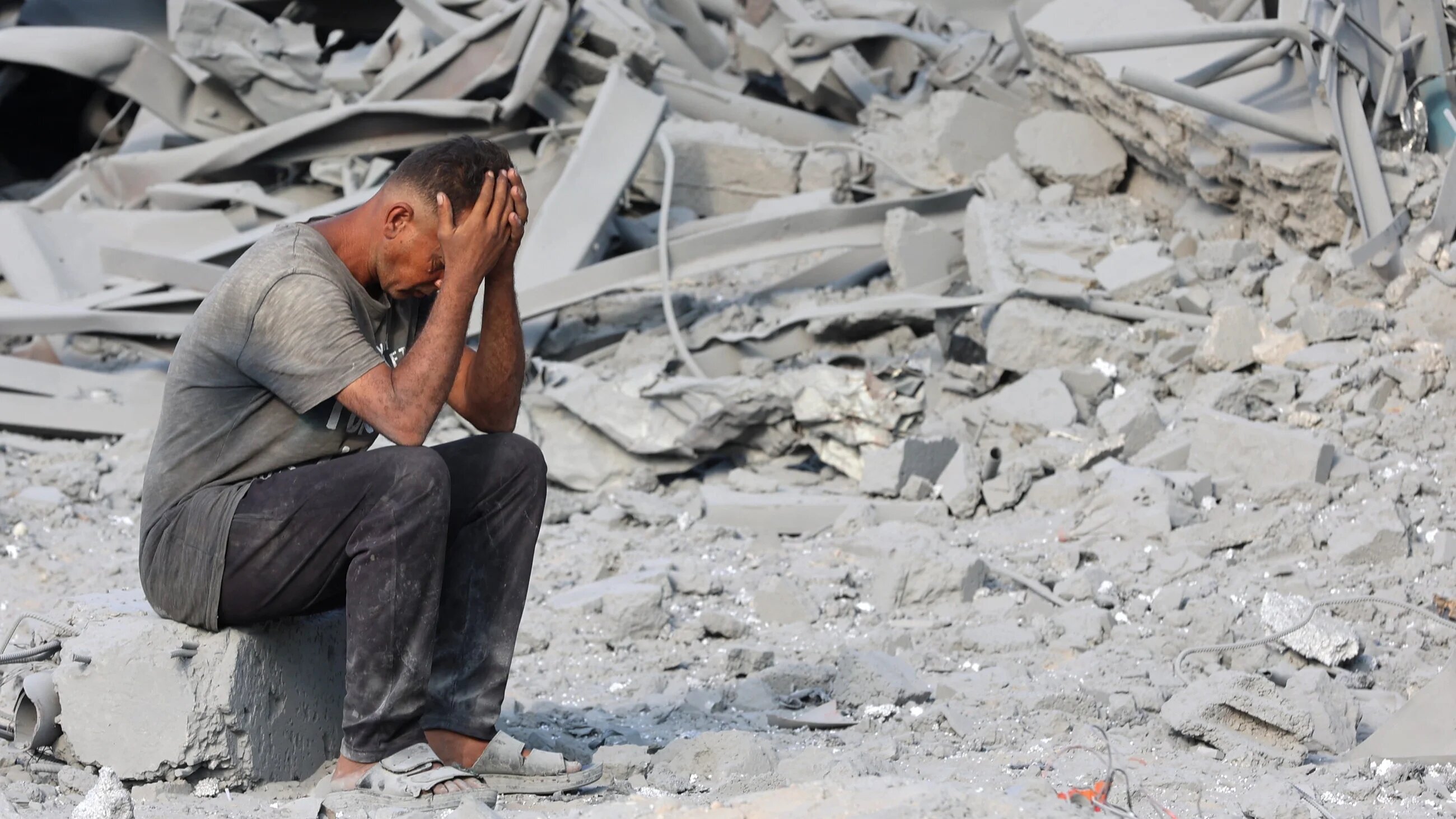 A Palestinian man reacts to the destruction after an overnight strike on the Sheikh Radwan Health Centre, north of Gaza City, on 6 August 2025 (AFP/Omar al-Qattaa)