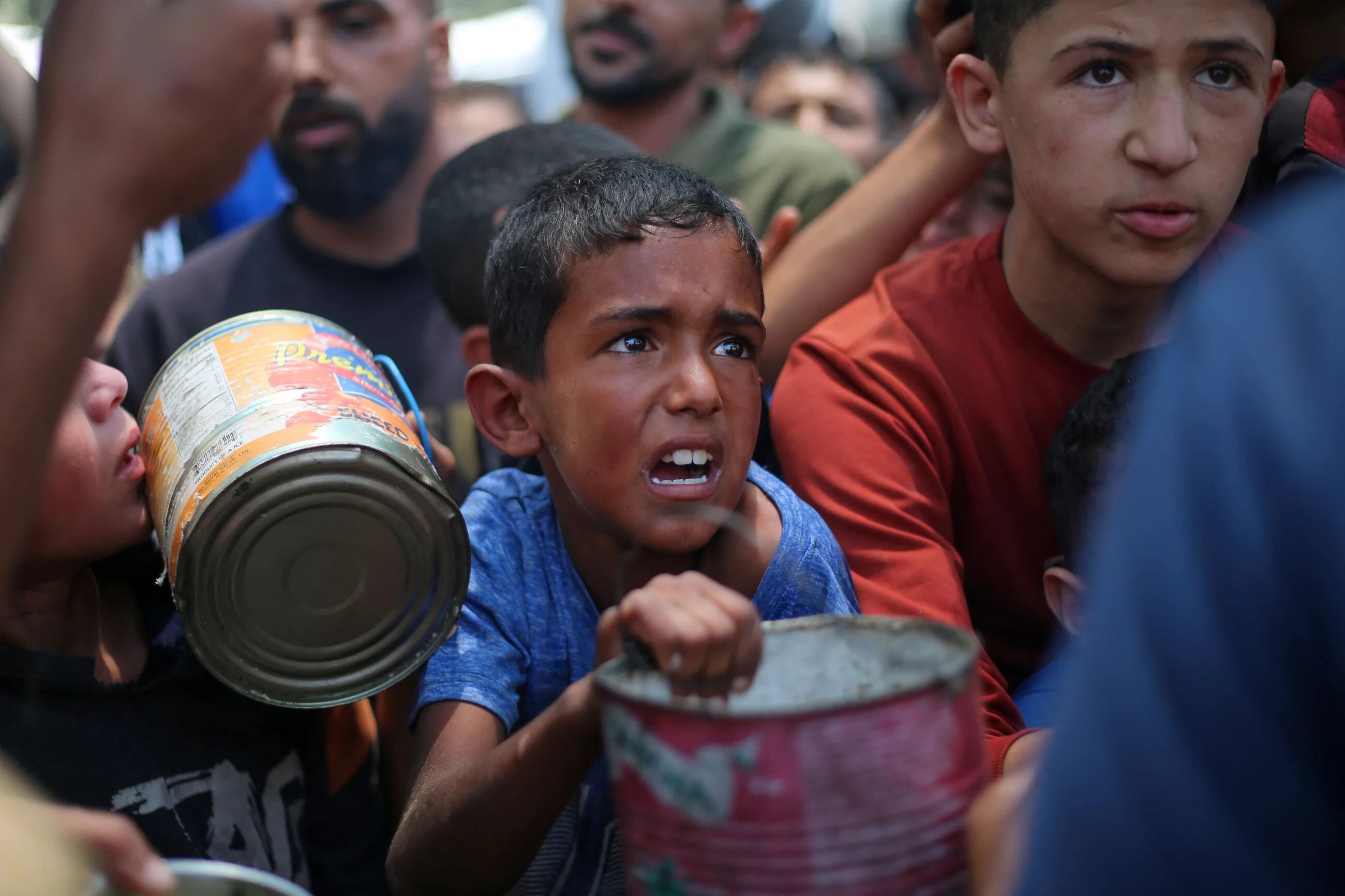 Palestinian children wait for food at an aid distribution point in Nuseirat, central Gaza, on 11 June, 2025 (AFP/Eyad Baba)