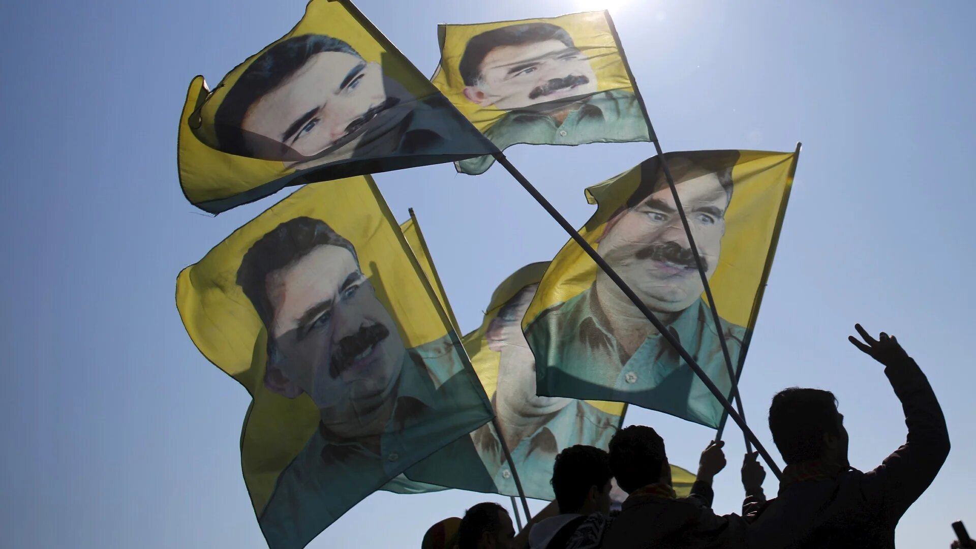 Demonstrators wave flags with the image of Abdullah Ocalan during a rally celebrating Newroz in Istanbul in 2015 (Reuters/Murad Sezer)