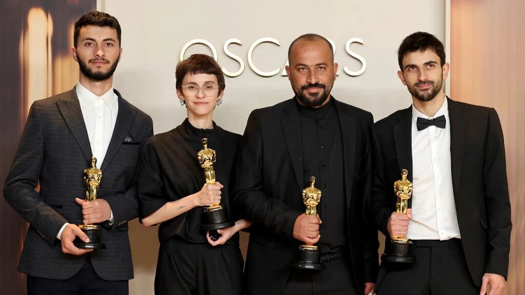 L-R: Basel Adra, Rachel Szor, Hamdan Ballal and Yuval Abraham, whose documentary No Other Land won an Oscar, pose in Hollywood on 2 March 2025 (Mike Coppola/Getty Images/AFP)