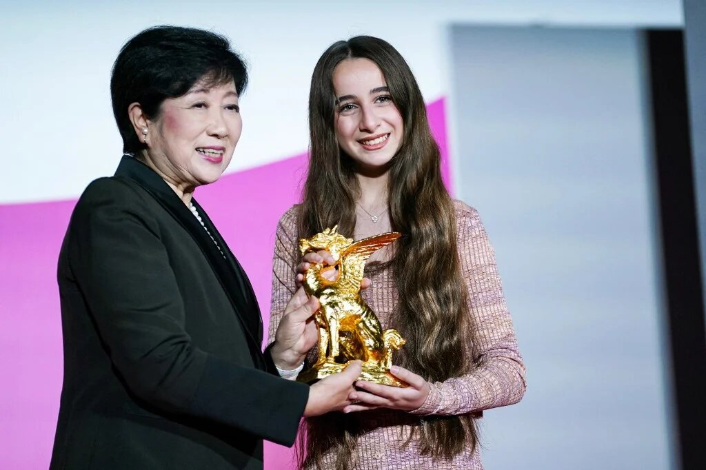 Actress Wardi Eilabouni (R), who starred in 'Palestine 36', receives a trophy from Tokyo Governor Yuriko Koike after the film won the Tokyo International Film Festival’s Governor of Tokyo Award/Tokyo Grand Prix (AFP)
