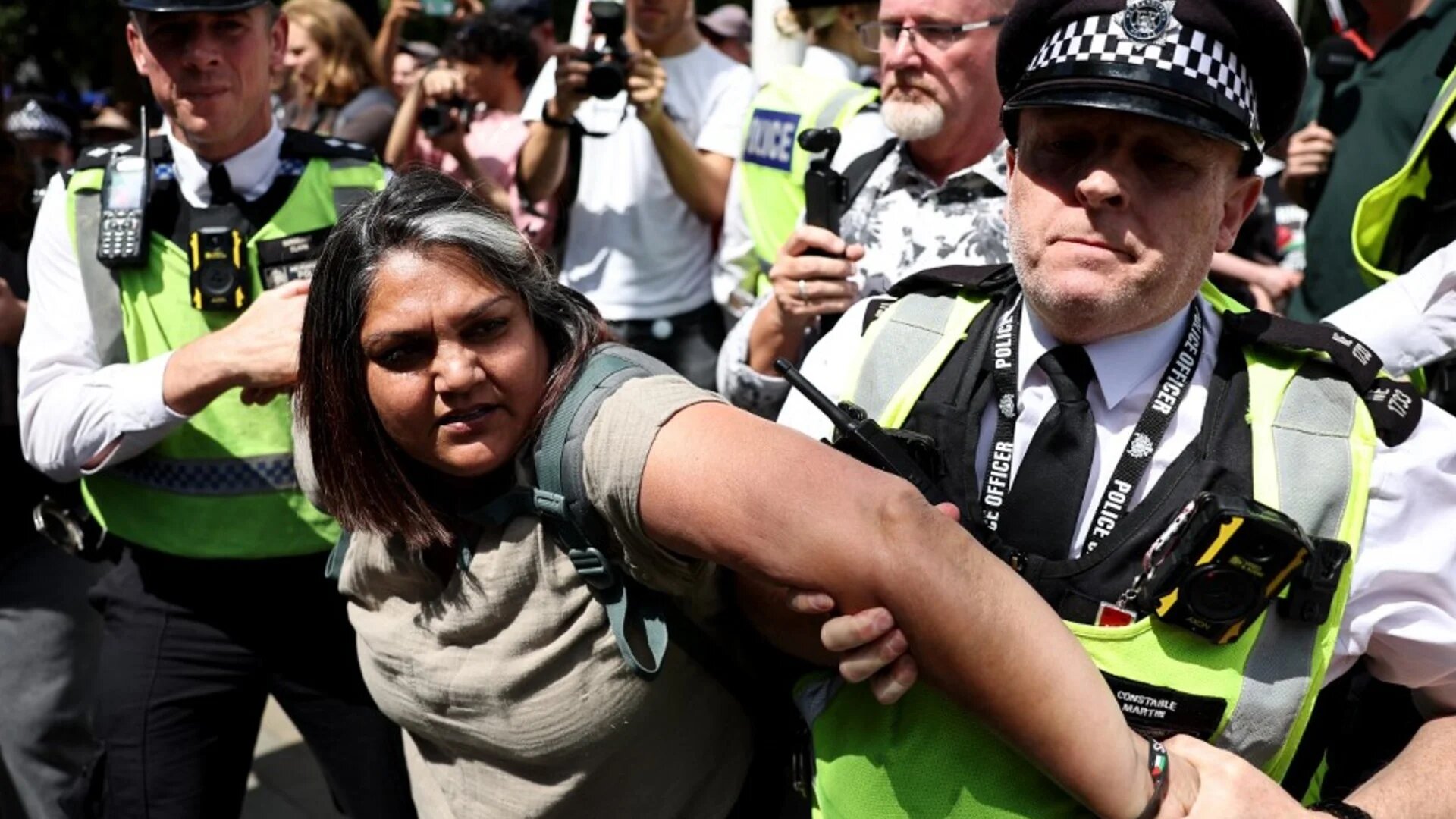 A protester is taken away by police at a 'Lift The Ban' demonstration in central London on 9 August (AFP)