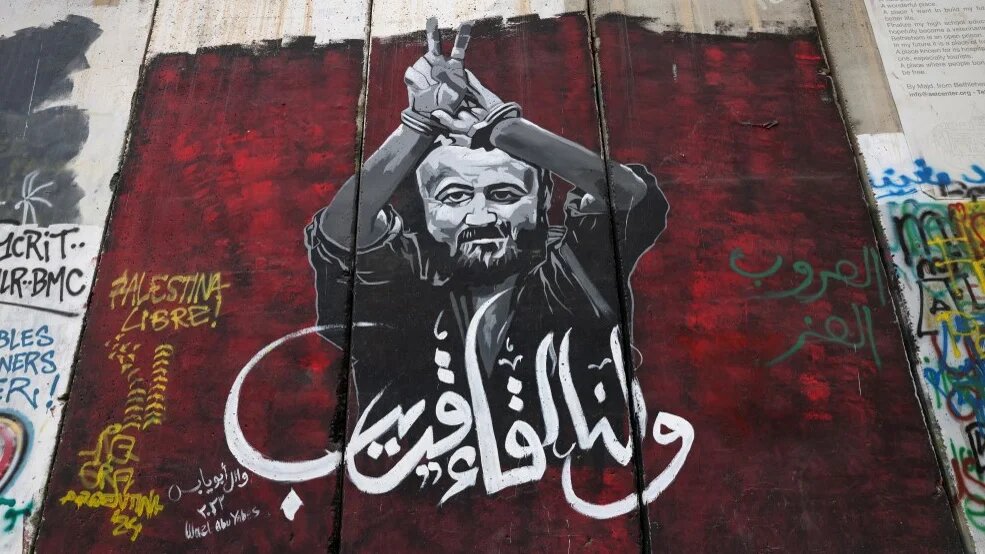 A mural depicts Palestinian prisoner Marwan Barghouti, along Israel’s separation wall in Bethlehem, in the occupied West Bank, on 24 December 2024 (Ahmad Gharabli/AFP)