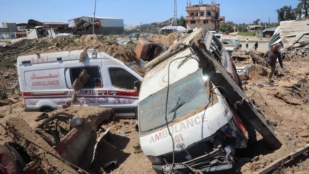 Palestinians inspect the damage at an ambulance repair yard hit by Israeli strikes in Gaza’s al-Maghazi refugee camp on 24 March 2025 (Eyad Baba/AFP)