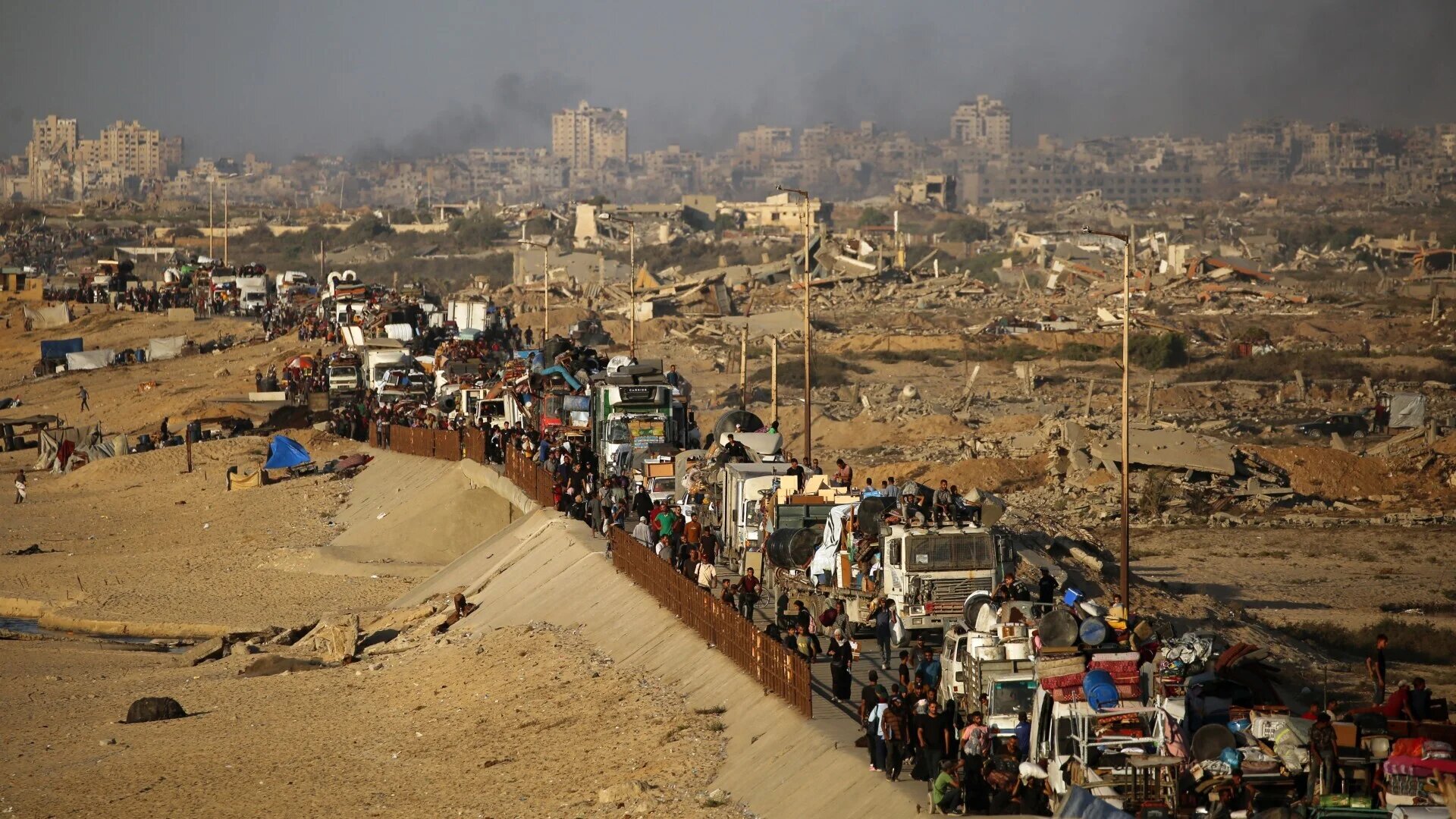 Displaced Palestinians move with their belongings southwards on a road in the Nuseirat refugee camp area in the central Gaza Strip on 23 September 2025 (AFP/Eyad Baba)