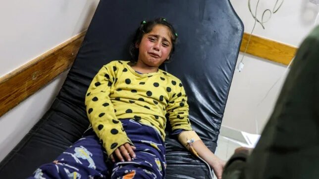 A young Palestinian injured by Israeli bombardment is hooked to an IV at a hospital in Beit Lahia, Gaza, on 18 April 2025 (Bashar Taleb/AFP)
