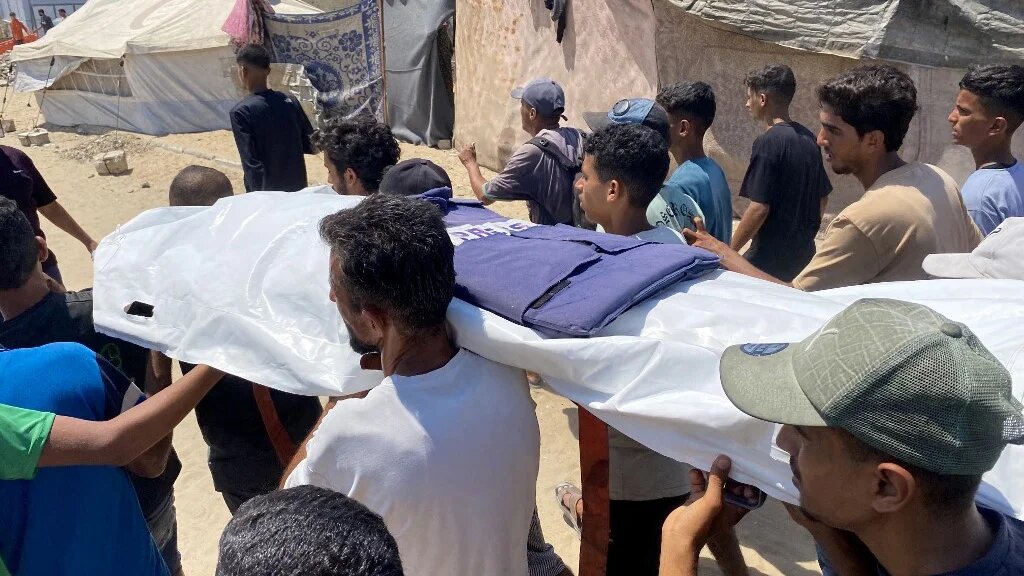 Mourners carry the body of one of five journalists killed in an Israeli strike on Nasser Hospital in Khan Younis, Gaza, during their funeral on 25 August 2025 (AFP)