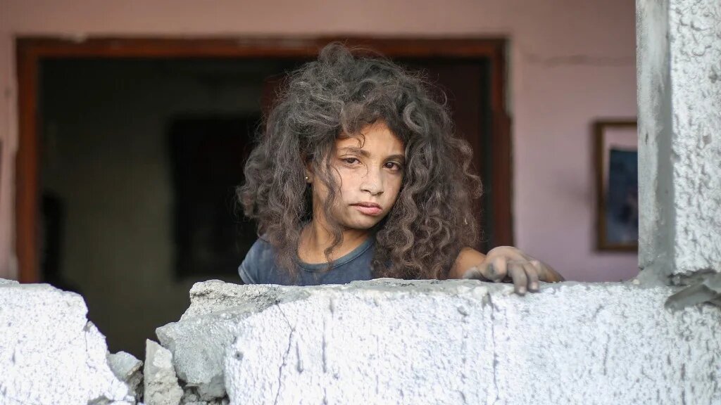 A Palestinian girl stands near the rubble of a residential house in Deir al-Balah, Gaza, on 1 July 2025, after overnight Israeli strikes (Eyad Baba/AFP)