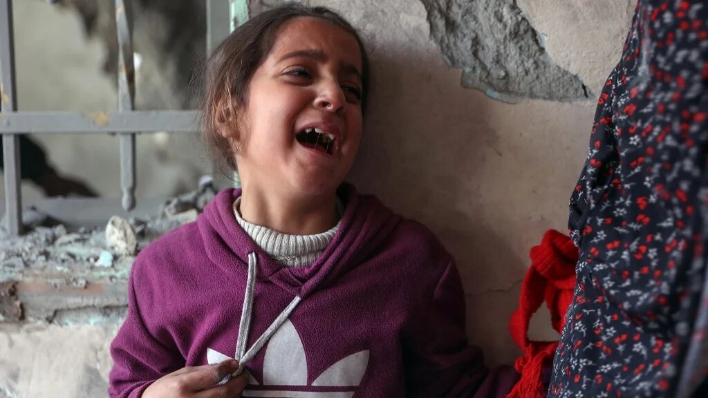 A child cries at the site of an Israeli strike on a residential area of Gaza City’s Tuffah neighbourhood on 26 December 2024 (Omar al-Qattaa/AFP)