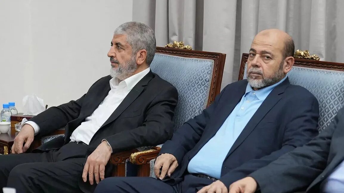 This handout picture provided by the Iranian foreign ministry on 31 October 2023 shows senior Hamas member Mousa Abu Marzouk (R) and senior leader Khaled Meshaal (L) attending a meeting in the Qatari capital Doha (Iranian Foreign Ministry/AFP)