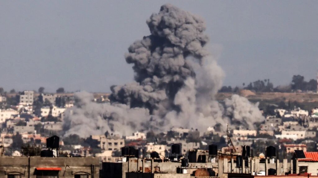 This picture taken from Rafah, in the southern Gaza Strip, shows smoke rising over buildings in Khan Younis during an Israeli bombardment on 1 February 2024 (Mahmud Hams/AFP)