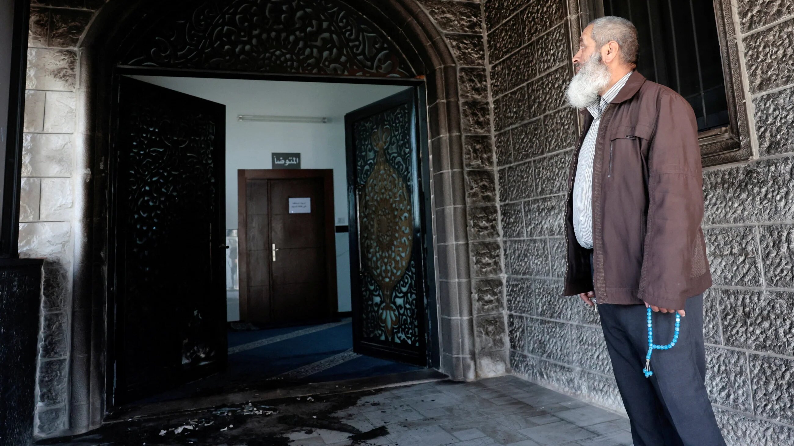 A Palestinian inspects damage to a mosque in Nablus, West Bank, after a settler attack, 23 February, 2026 (Reuters/Mohamad Torokman)
