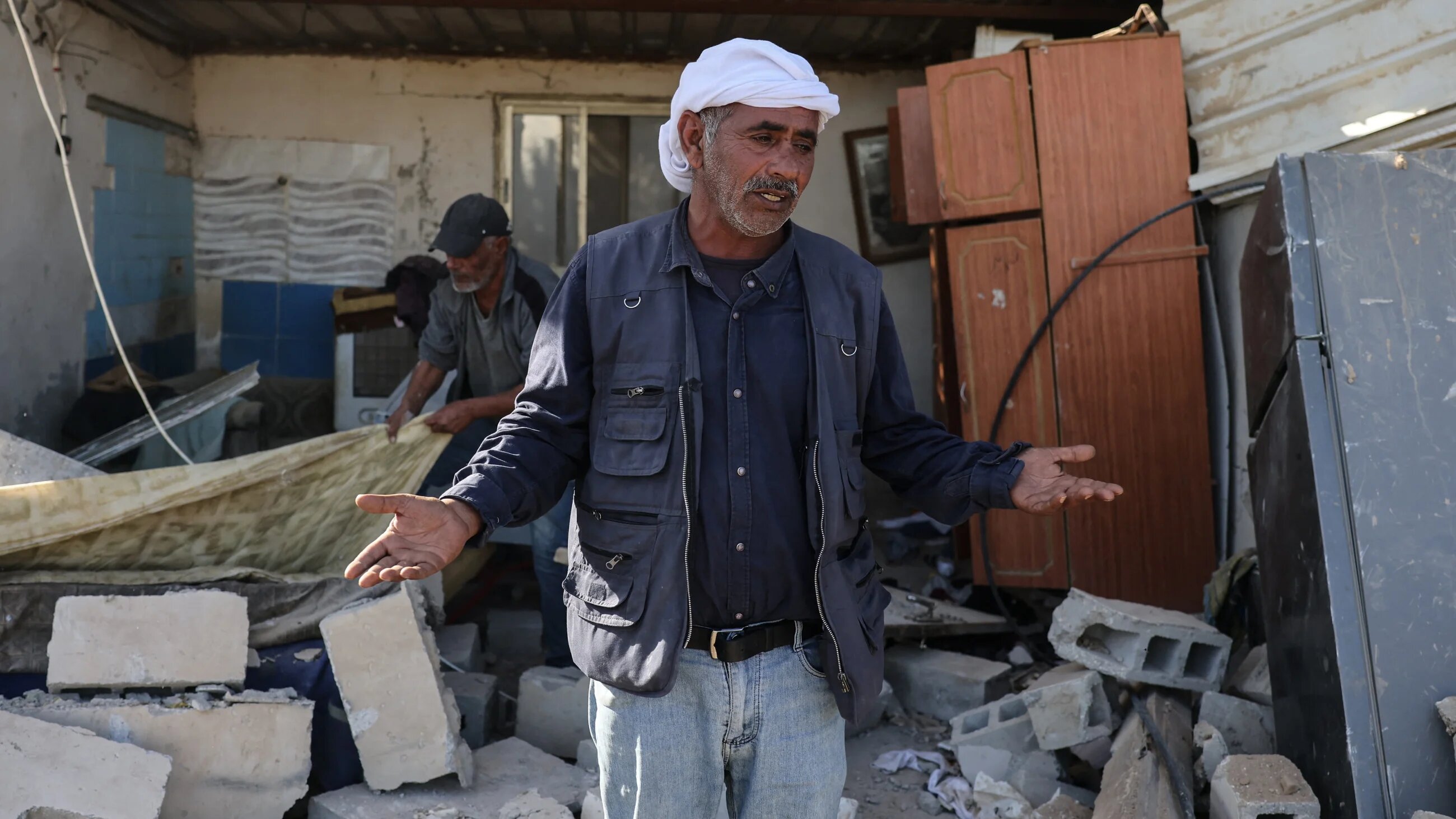 A Palestinian man stands on the rubble of a house demolished by Israeli settlers in Jericho, occupied West Bank, on 11 February 2026 (AFP/Ahmad Gharabli)