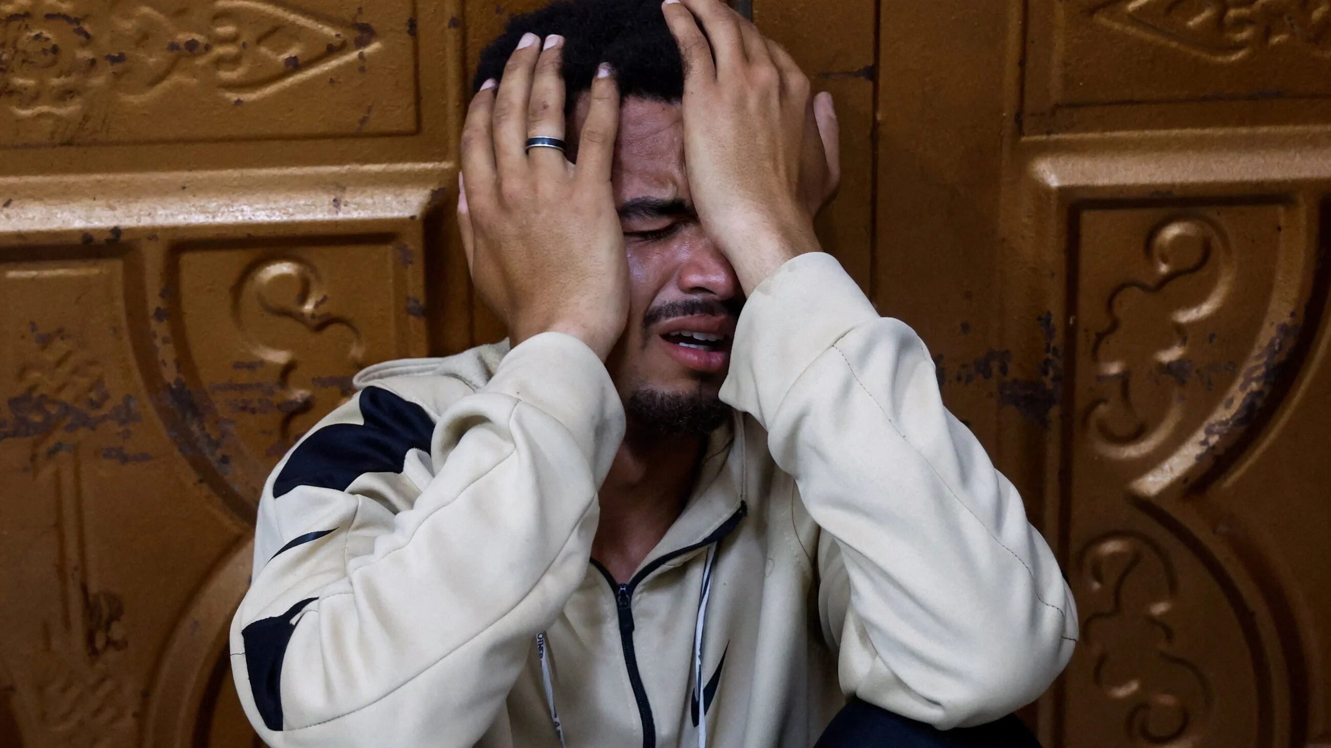 A Palestinian mourns police officers killed in an Israeli strike, in Khan Younis, south Gaza, on 10 May, 2026 (Haseeb Alwazeer/Reuters)
