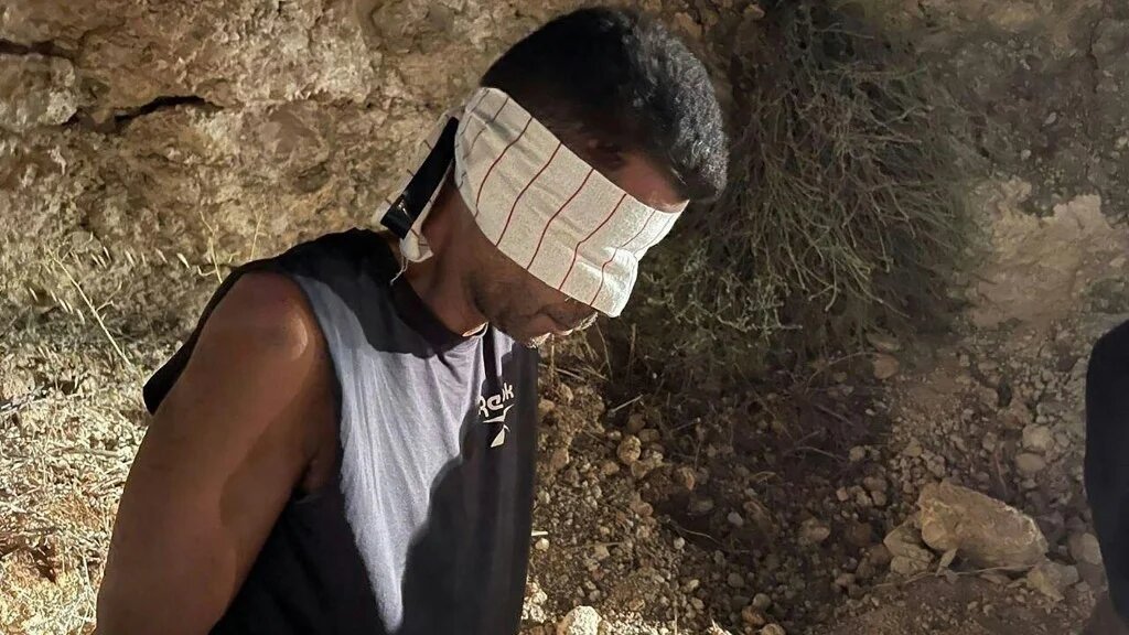 A blindfolded Palestinian prisoner is pictured on 11 September 2021 (Israeli Police/AFP)