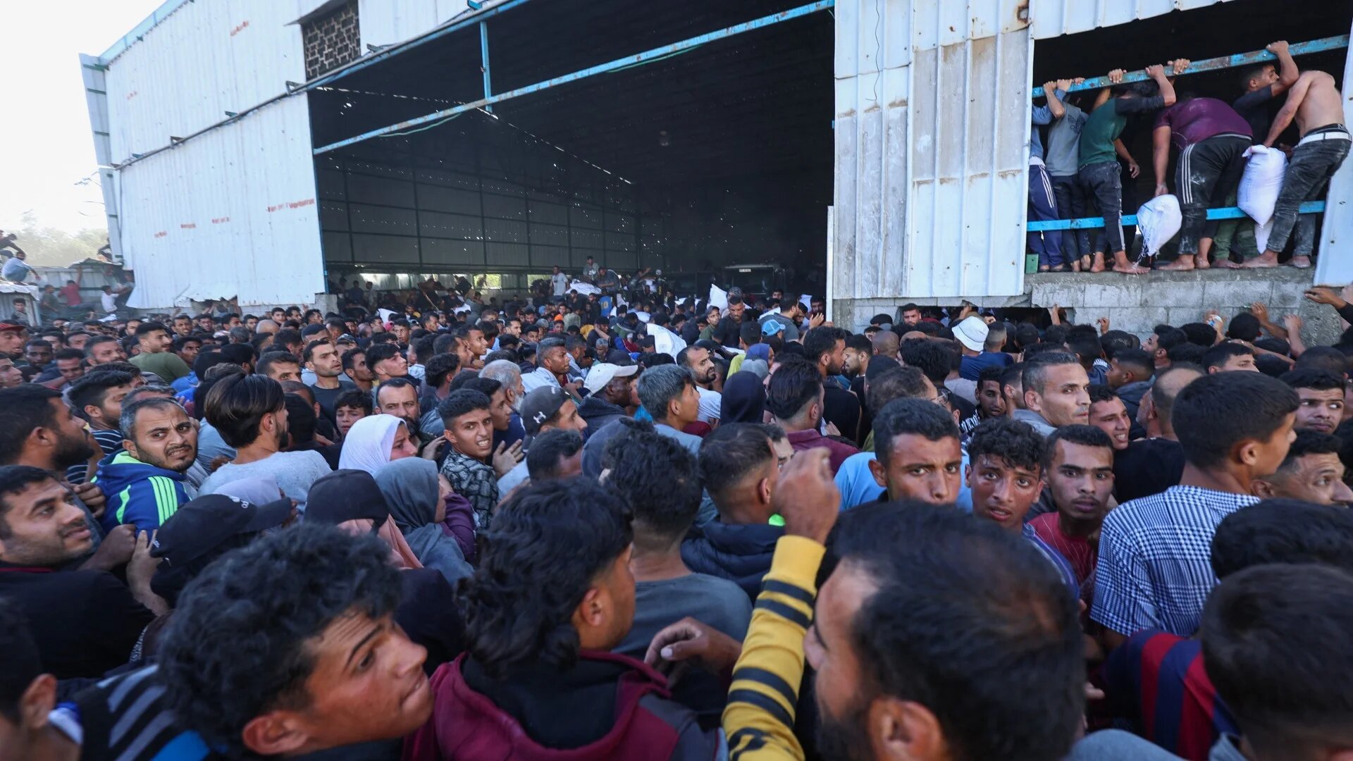 Displaced Palestinians search for food aid in Deir el-Balah in the central Gaza Strip on 28 May 2025 (AFP/Eyad Baba)