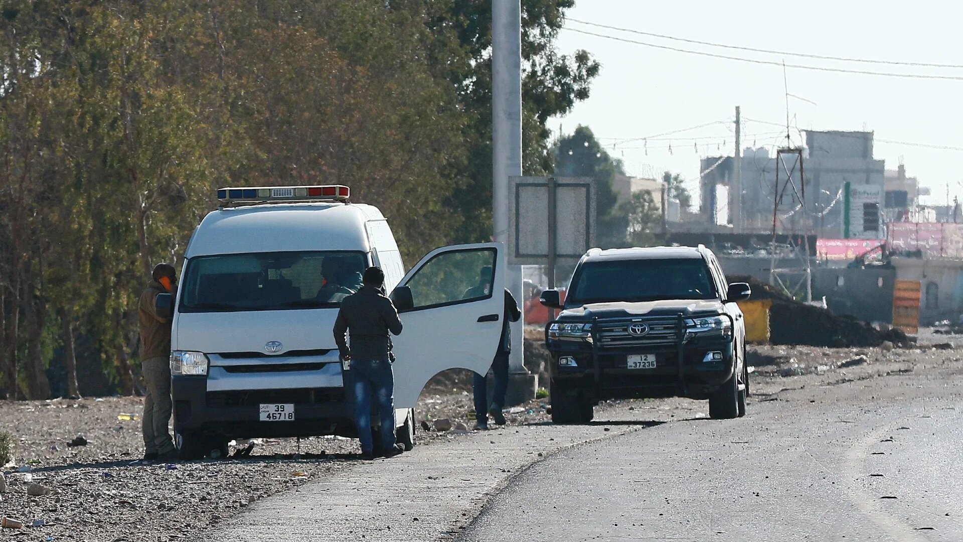A forensic team collects evidence on 16 December 2022, hours after a senior police officer was shot dead in the southern Jordanian city of Maan (AFP)