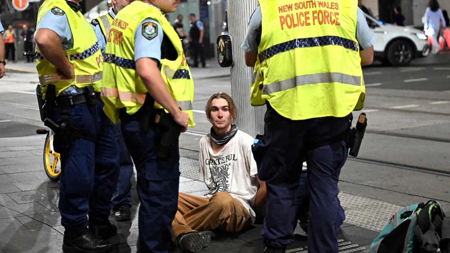 Police detain a man after scuffles during a pro-Palestinian demonstration against Israeli President Isaac Herzog's visit to Australia in Sydney on 9 February 2026 (AFP)