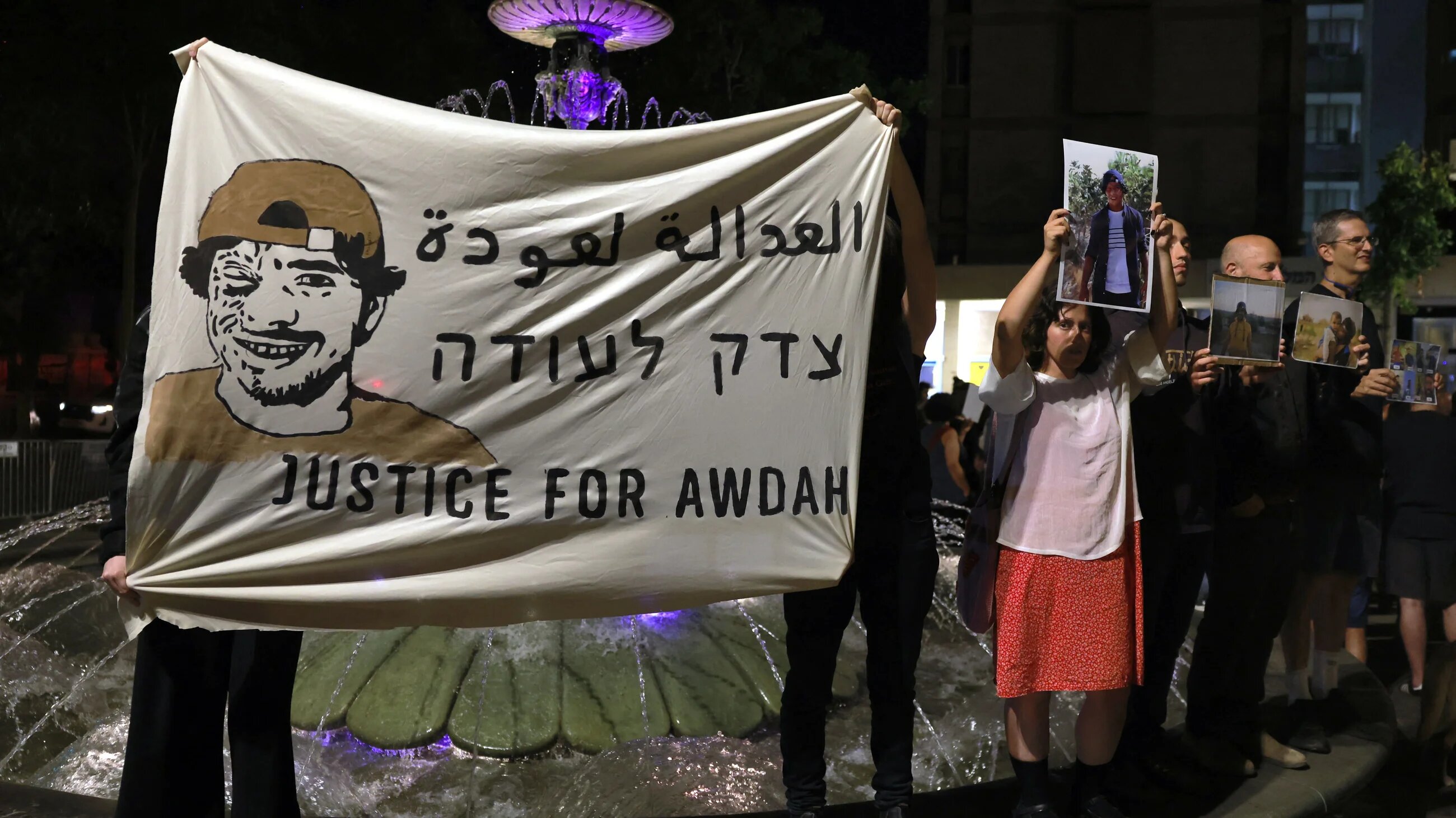 Israeli left-wing activists hold placards and portraits of activist Awdah Muhammad Hathaleen as they demand for the return of his body and the release of his family members in central Jerusalem on 3 August, 2025 (AFP/Menahem Kahana)