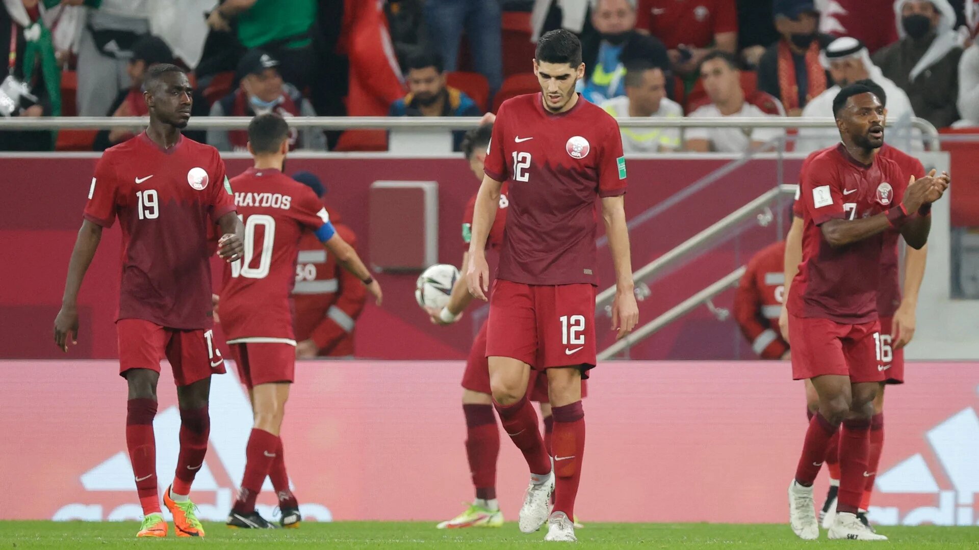Qatar's players react after conceding during the FIFA Arab Cup 2021 semi-final match against Algeria at Al-Thumama stadium Doha (AFP)