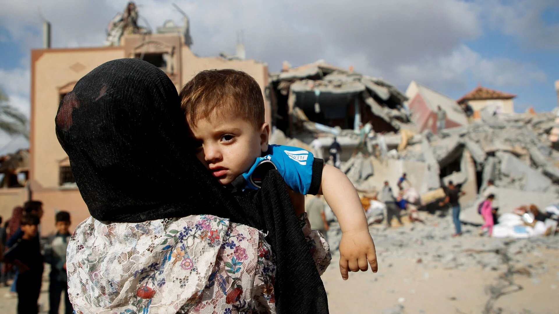 A Palestinian child looks on at the site of an Israeli strike on a house in Rafah, in the southern Gaza Strip, 5 May (Reuters/Hatem Khaled)